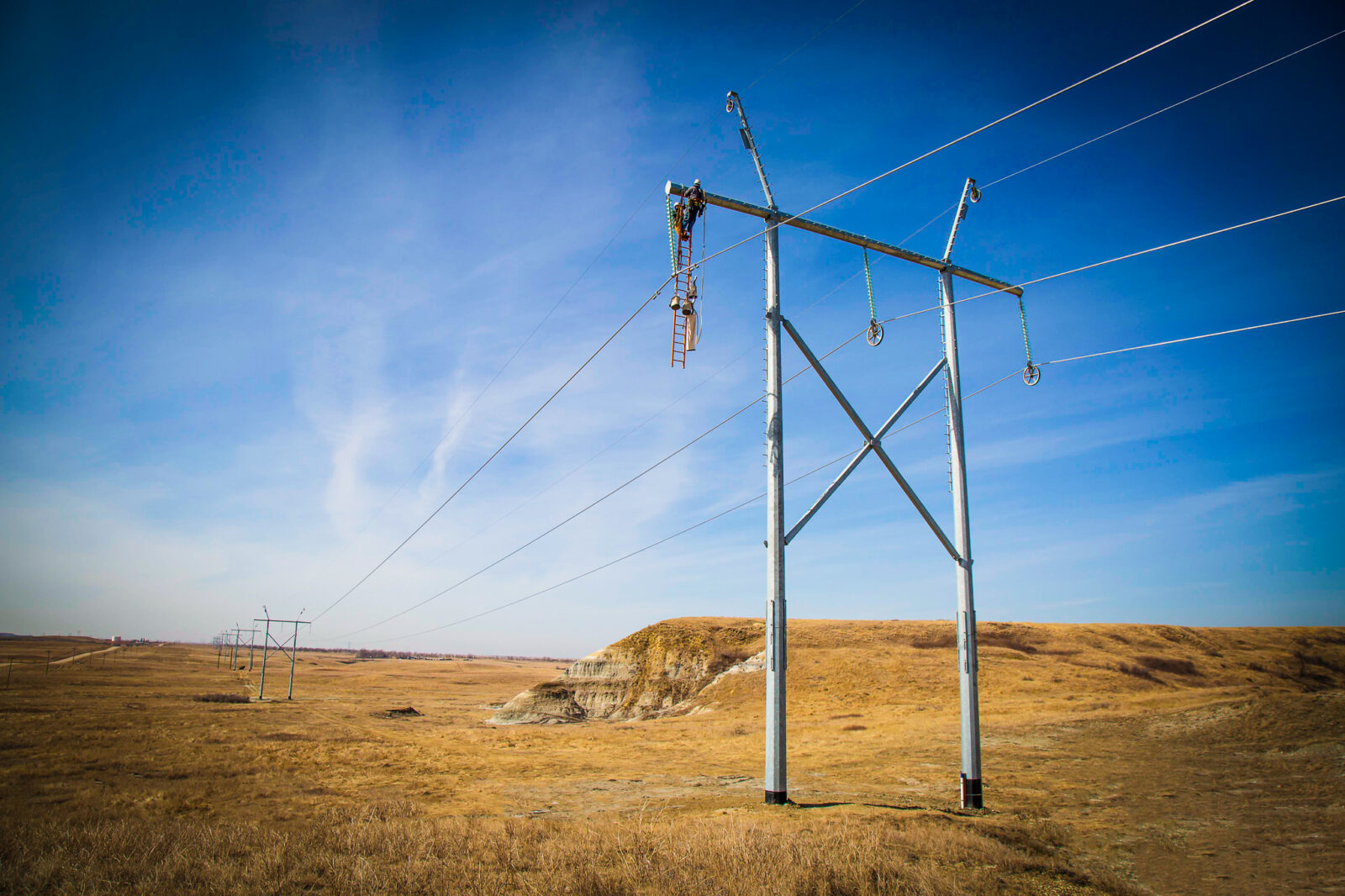 Two people working on the judson transmission towers