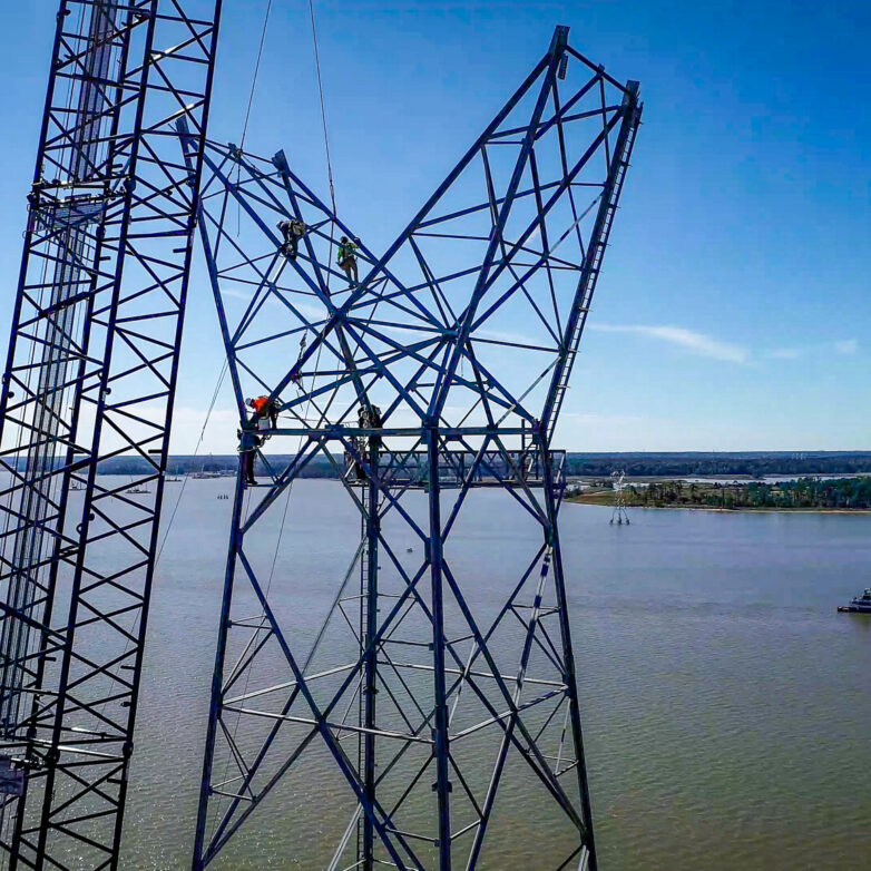 Group of workers on a transmission tower