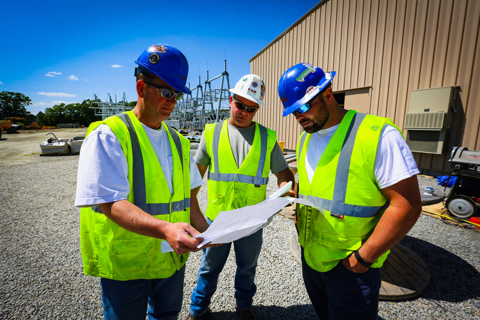 Three construction workers reviewing a blueprint