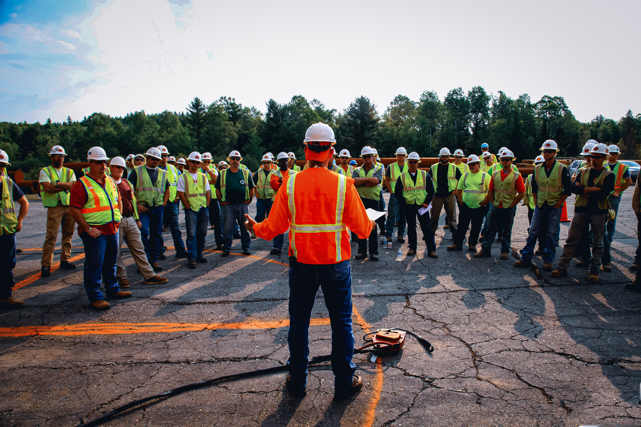 Team leader speaking to a group of construction workers