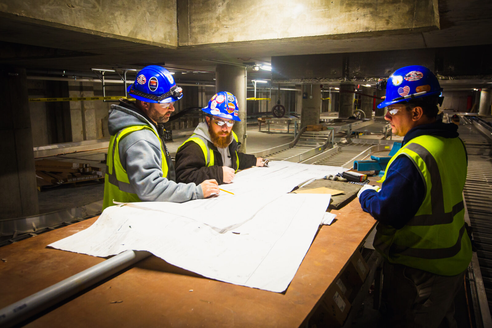 Group of construction workers reviewing a blueprint