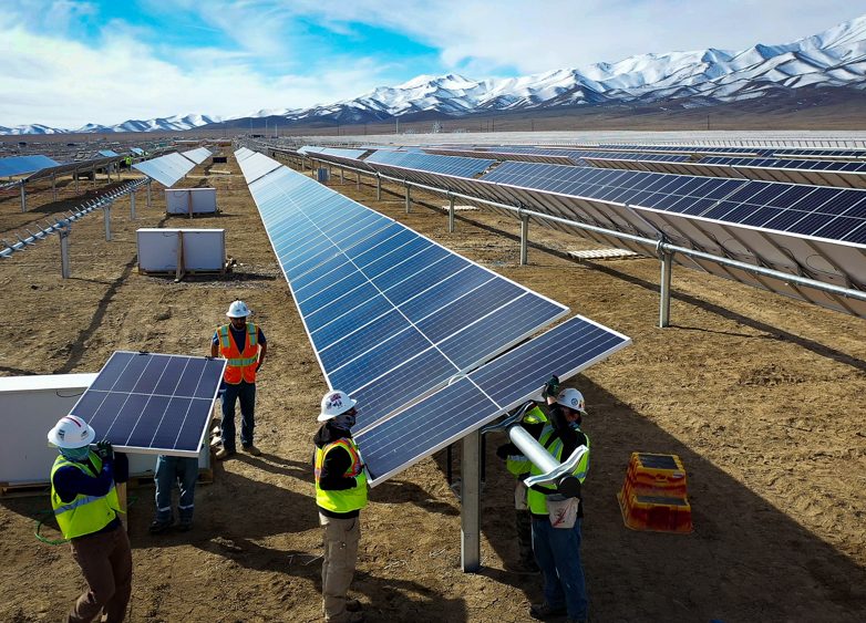 Workers install solar modules in Nevada